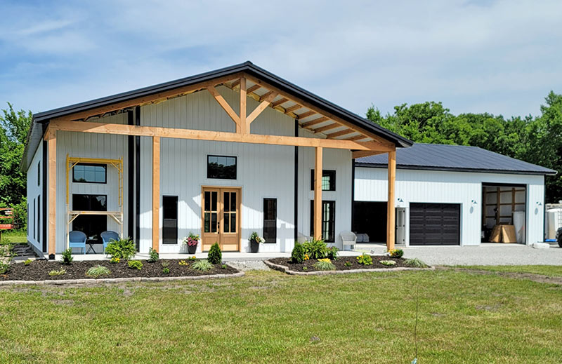 Building with black metal roof and white metal siding